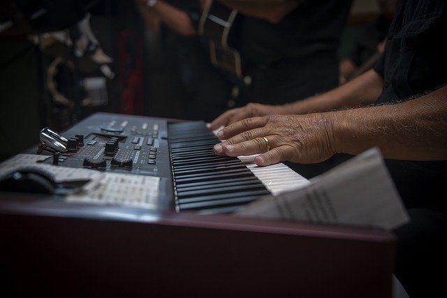 man playing keyboard piano